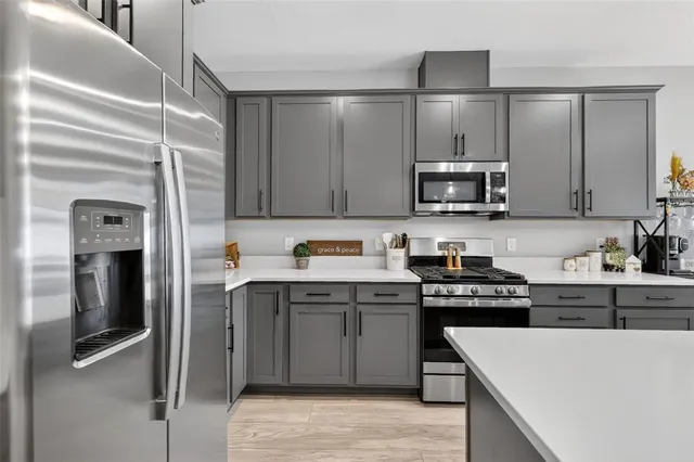 a kitchen with kitchen island a dining table and chairs