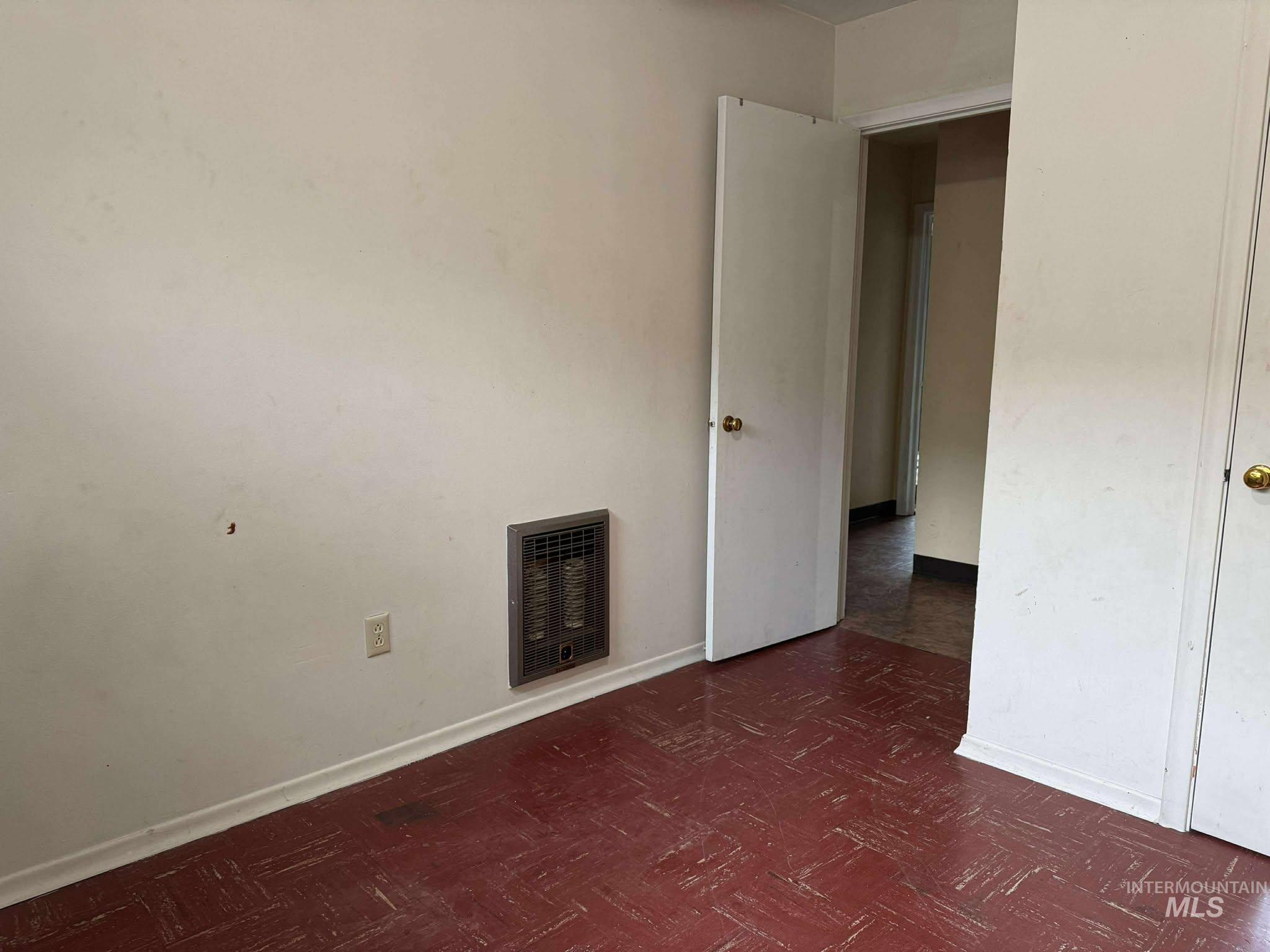 326 7th Street Lapwai, ID 83540 - Photo 3 of 5 Unfurnished bedroom featuring heating unit and dark floors