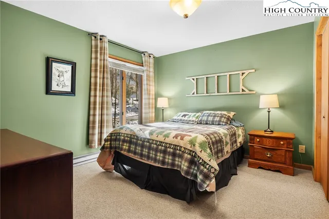 a bed sitting in a bedroom next to a lamp