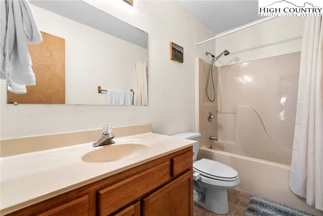a bathroom with a sink toilet vanity and shower