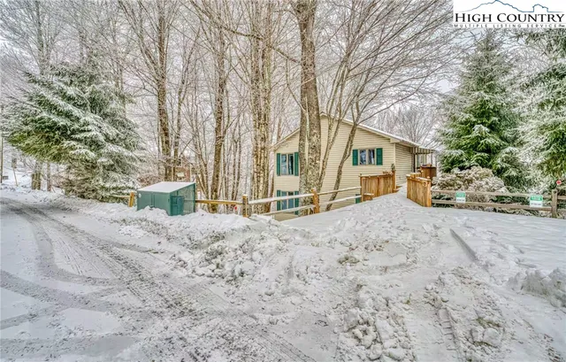 a view of a large house with a snow in the yard