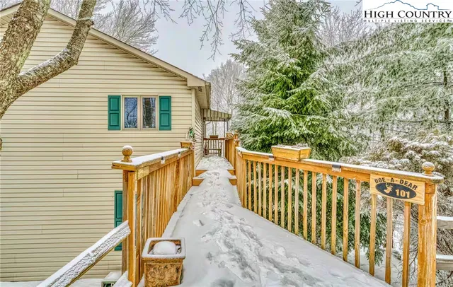 a view of a wooden house with a small yard