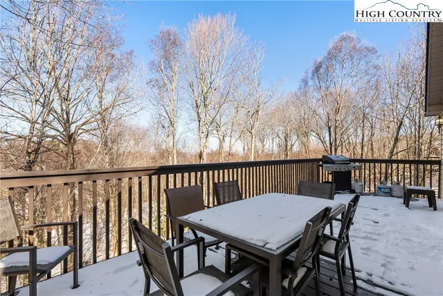 a view of a dinning table and chairs on the roof deck
