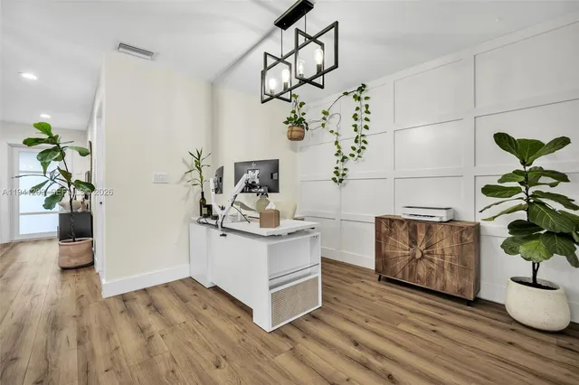 a living room with furniture a table and a large window