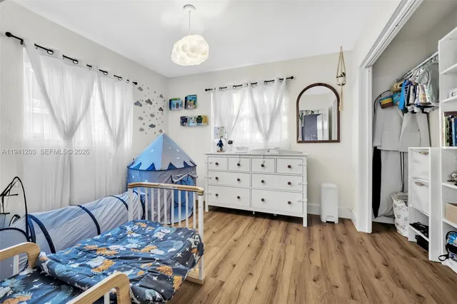a bedroom with furniture and a wooden floor