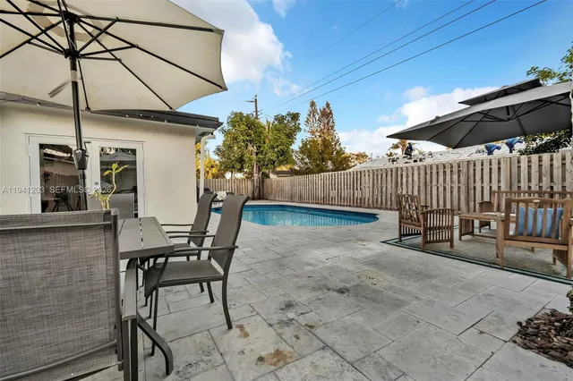 a view of swimming pool with a sitting area