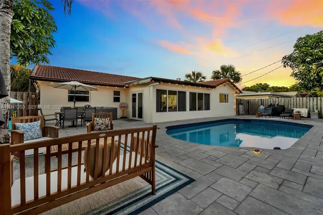 a view of a patio with a table and chairs