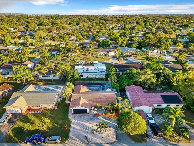 an aerial view of a houses with a swimming pool