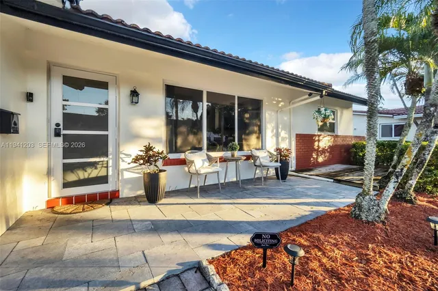 a view of a patio with swimming pool table and chairs