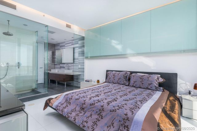 a bedroom with a bed and a fireplace