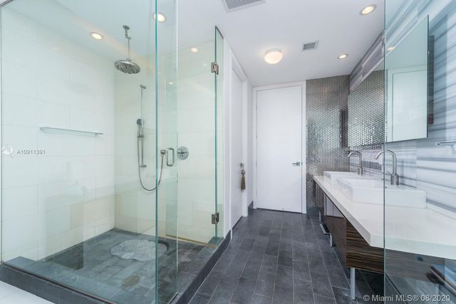 a bathroom with a shower and a sink