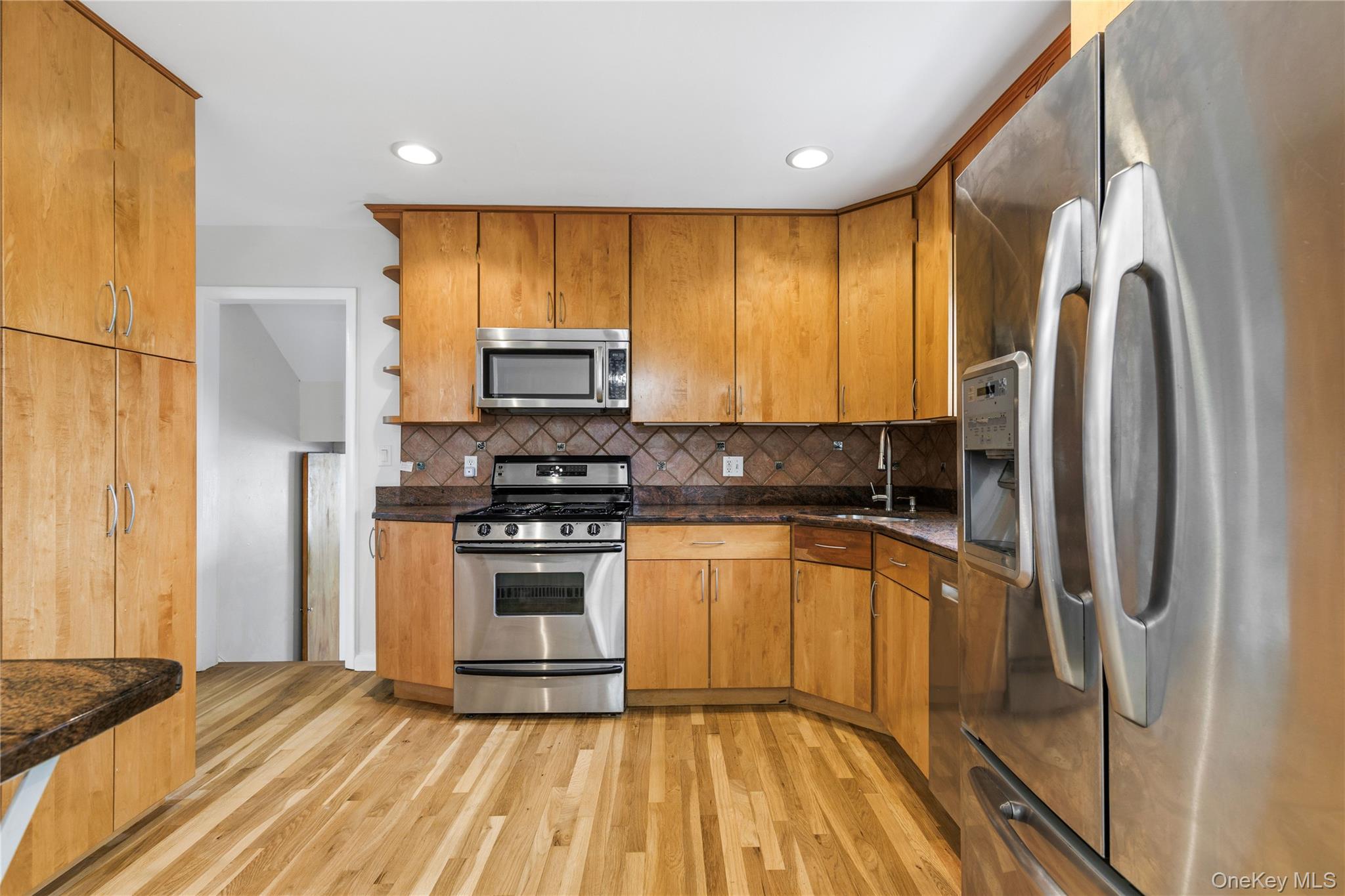 46 Mathews Street Harrison, NY 10528 - Photo 10 of 30 a kitchen with stainless steel appliances granite countertop a refrigerator a stove top oven a sink and dishwasher
