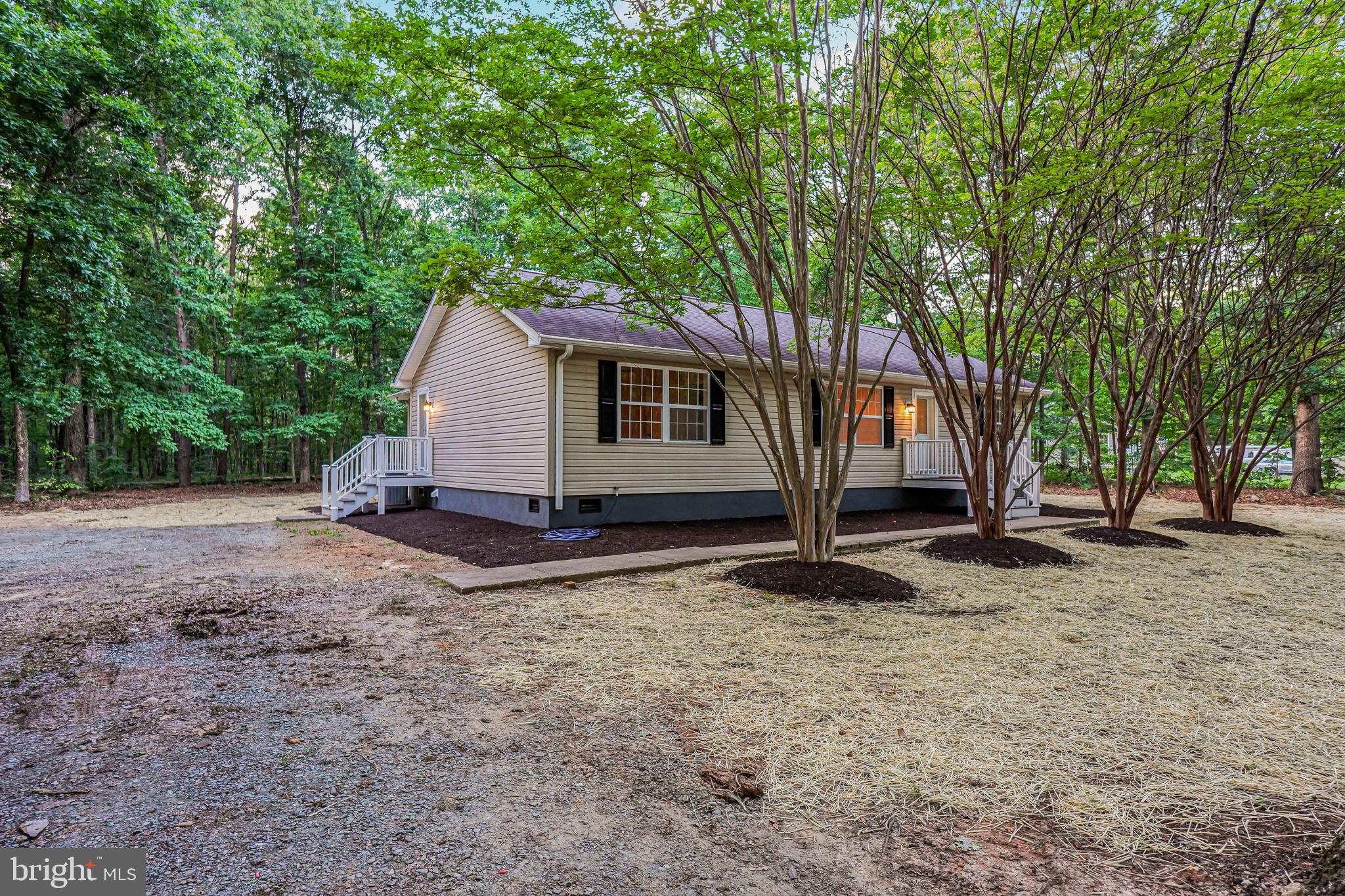 767 Loving Road Zion Crossroads, VA 22942 - Photo 32 of 33 a view of a house with backyard and trees