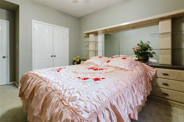 a bedroom with a bed and a potted plant