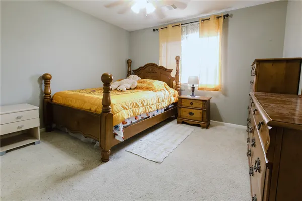 a bed sitting in a room next to a window