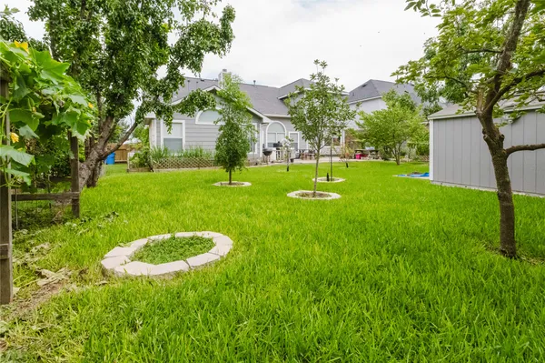 a swimming pool with outdoor seating and yard