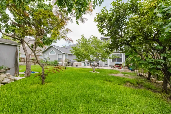 a backyard of a house with table and chairs