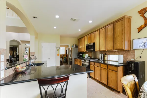a kitchen with stainless steel appliances granite countertop sink stove and cabinets