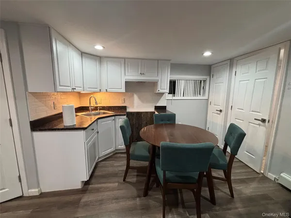 a kitchen with a table chairs refrigerator and cabinets