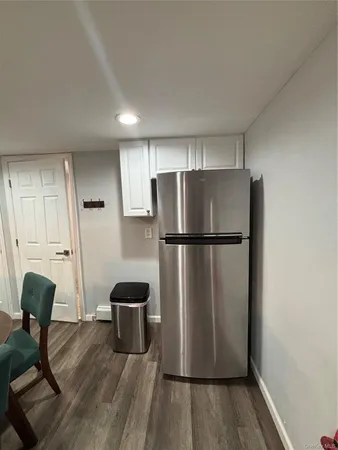 a kitchen with a refrigerator a stove and a wooden floors