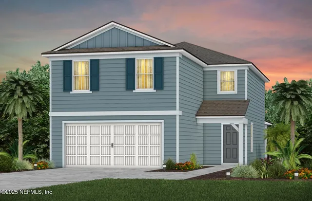 a front view of a house with a garden and plants