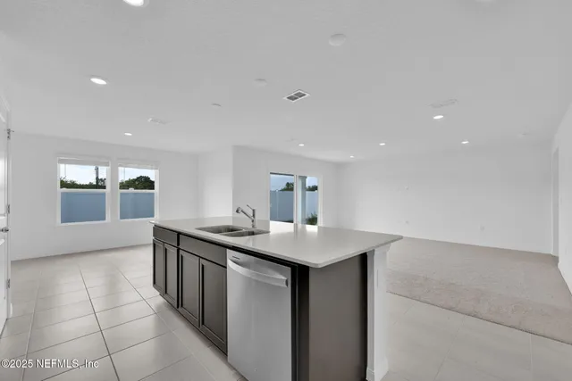 a view of kitchen with refrigerator and a sink