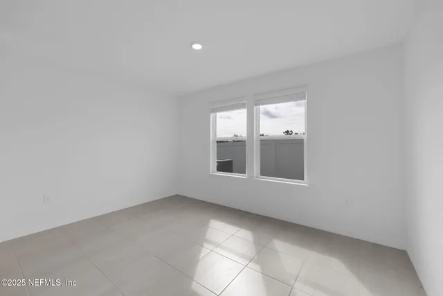 a living room with furniture a flat screen tv and kitchen view