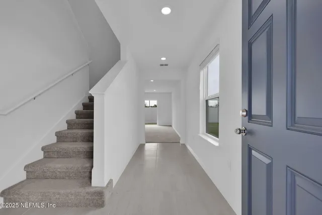 a kitchen with stainless steel appliances a refrigerator sink and microwave