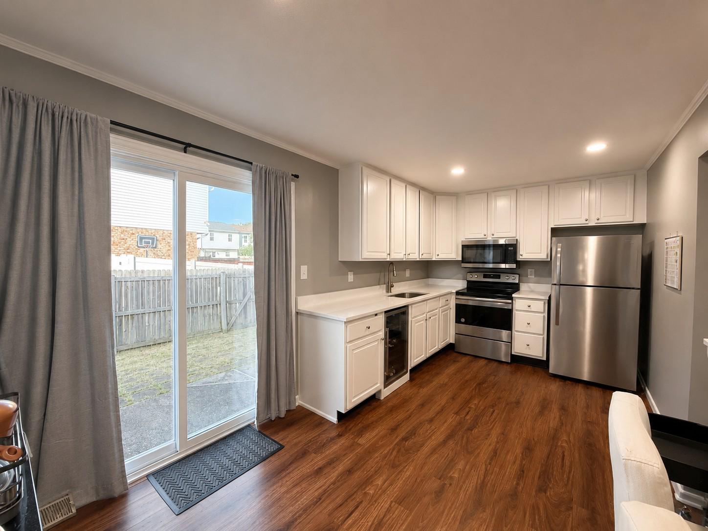 813 Thimbleberry Road, Unit 813 Baltimore, MD 21220 - Photo 11 of 32 Modern kitchen with sleek finishes leads to patio.