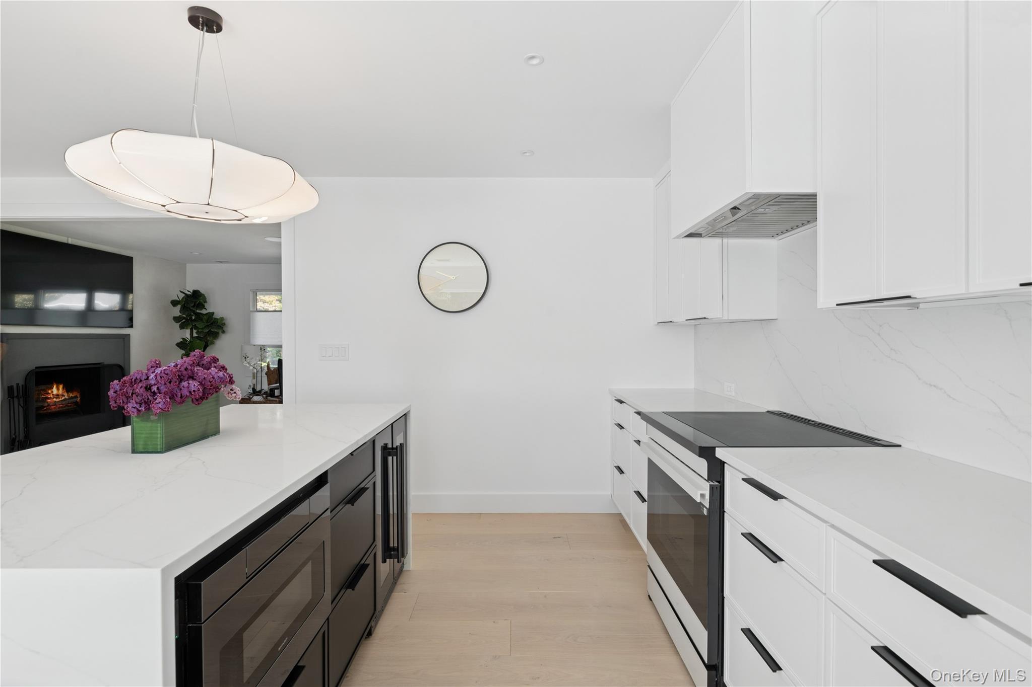 13 Sherwood Road Hampton Bays, NY 11946 - Photo 11 of 27 a kitchen with a sink a stove and cabinets