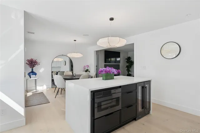 a view of a kitchen area with dining table and chairs
