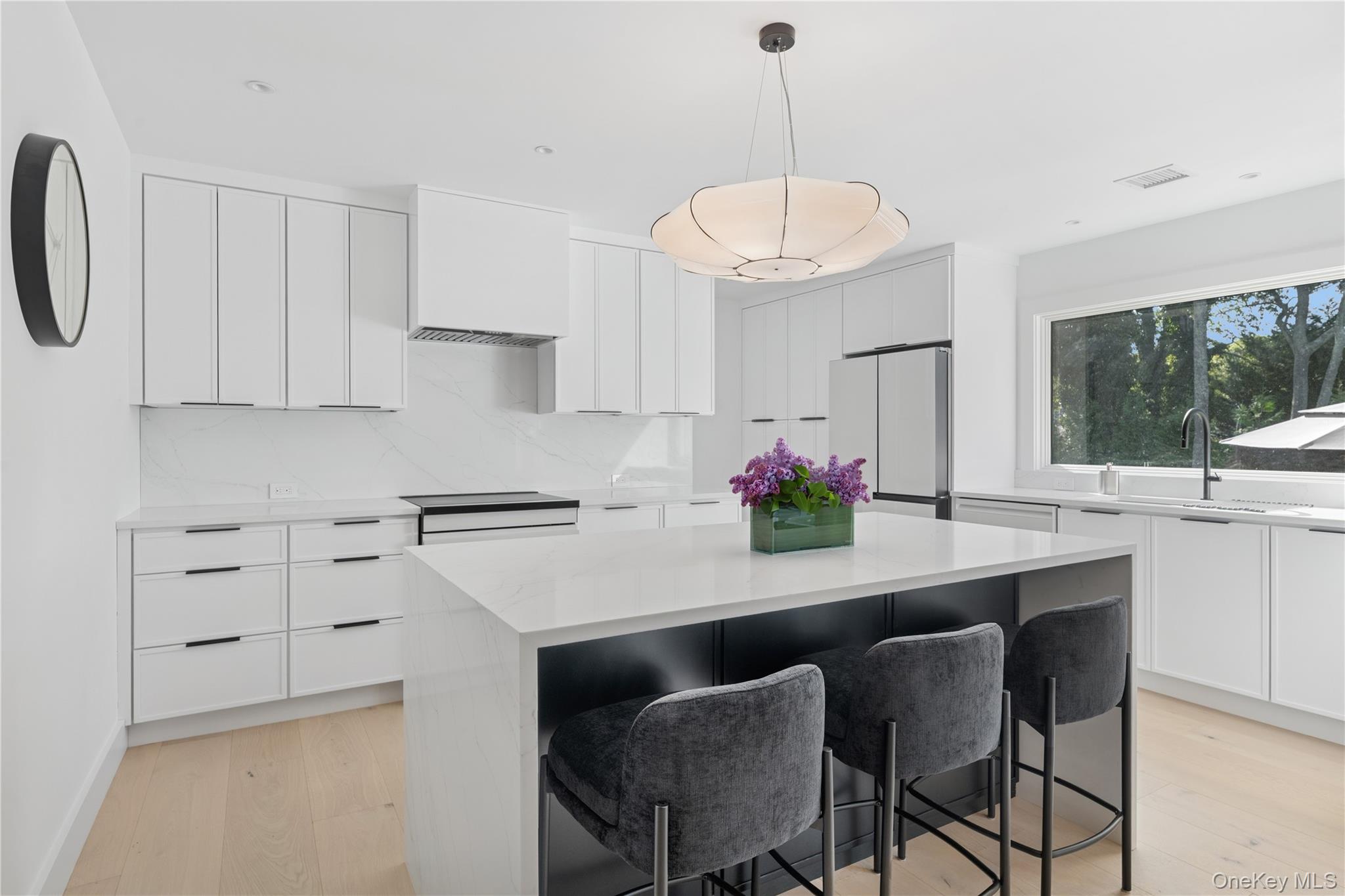 13 Sherwood Road Hampton Bays, NY 11946 - Photo 17 of 27 a kitchen with a dining table chairs sink and stove