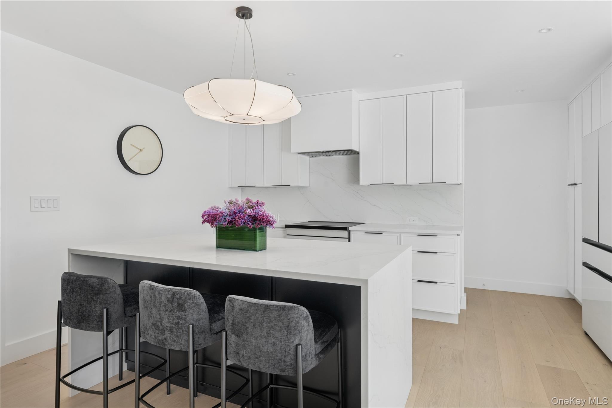 13 Sherwood Road Hampton Bays, NY 11946 - Photo 18 of 27 a table with white cabinets and wooden floor