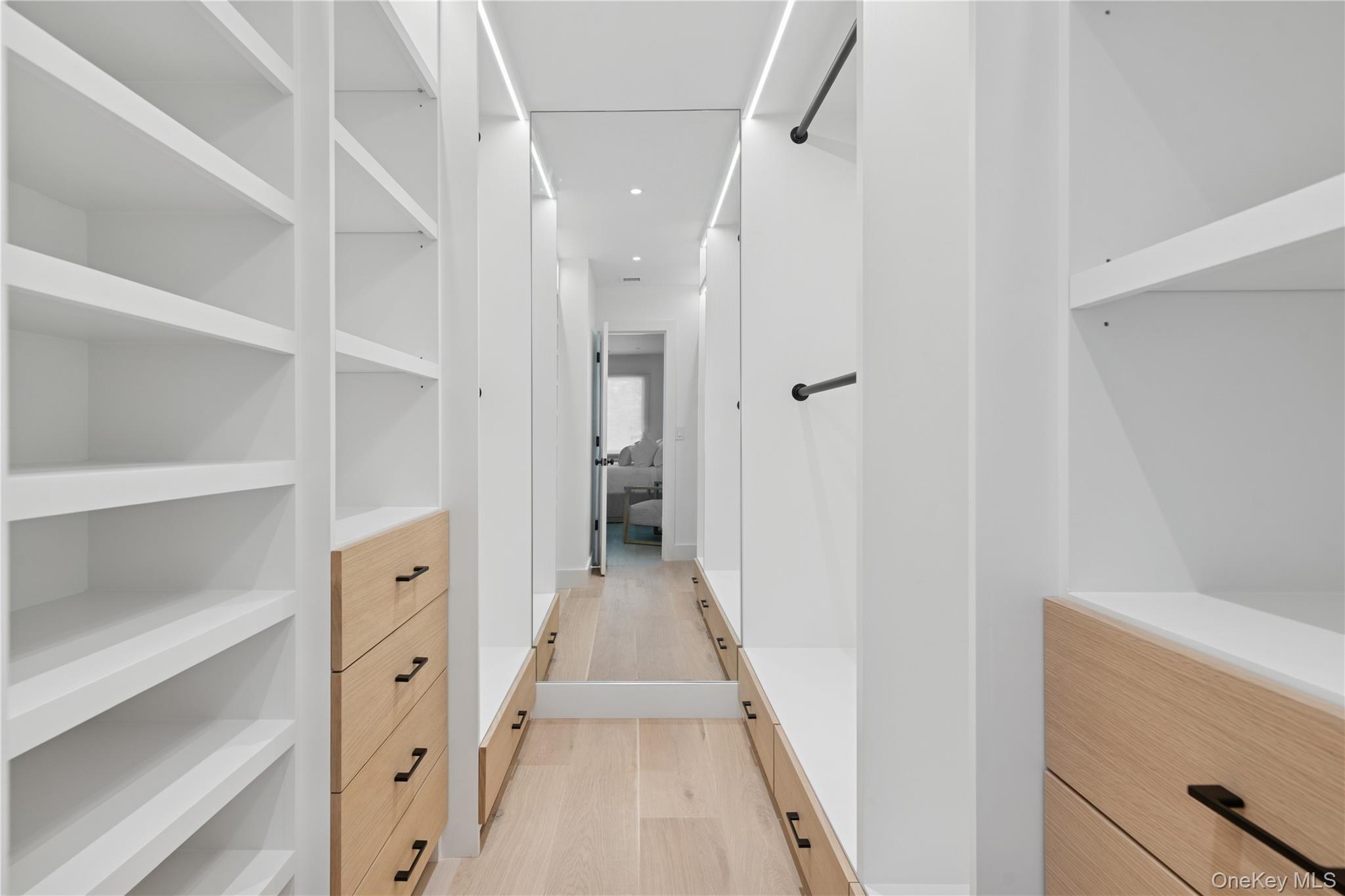 13 Sherwood Road Hampton Bays, NY 11946 - Photo 20 of 27 a view of a hallway with wooden floor and staircase