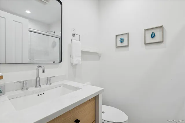 a bathroom with a sink toilet and mirror