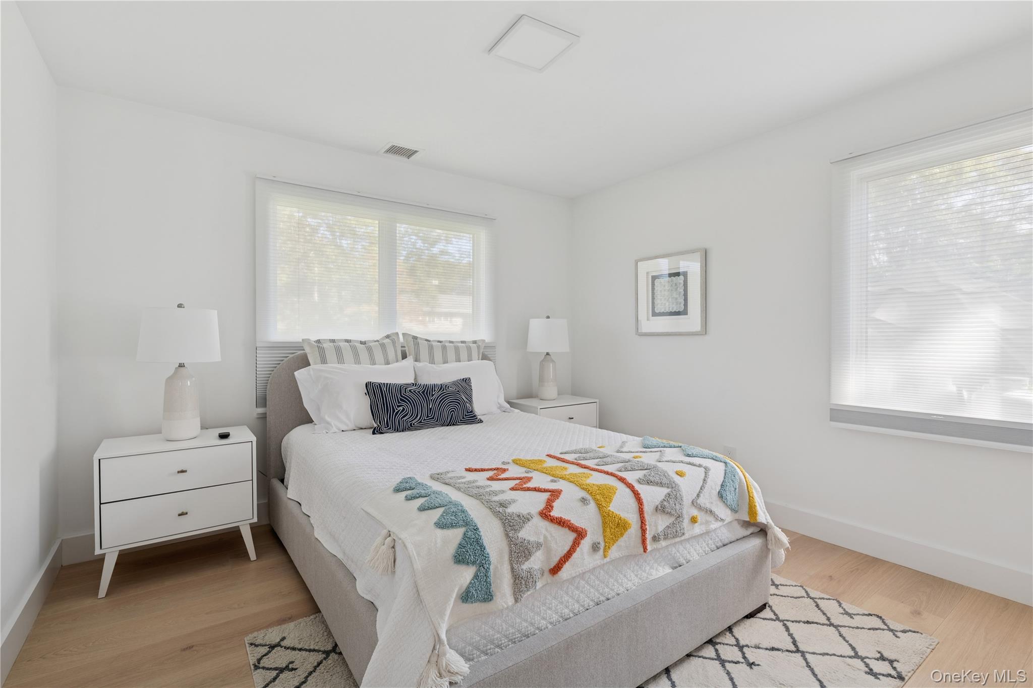 13 Sherwood Road Hampton Bays, NY 11946 - Photo 23 of 27 a bedroom with a bed and a window