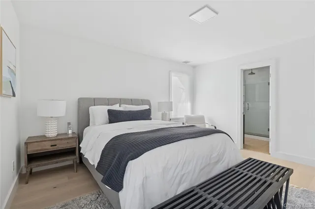 a bedroom with a bed and a night stand