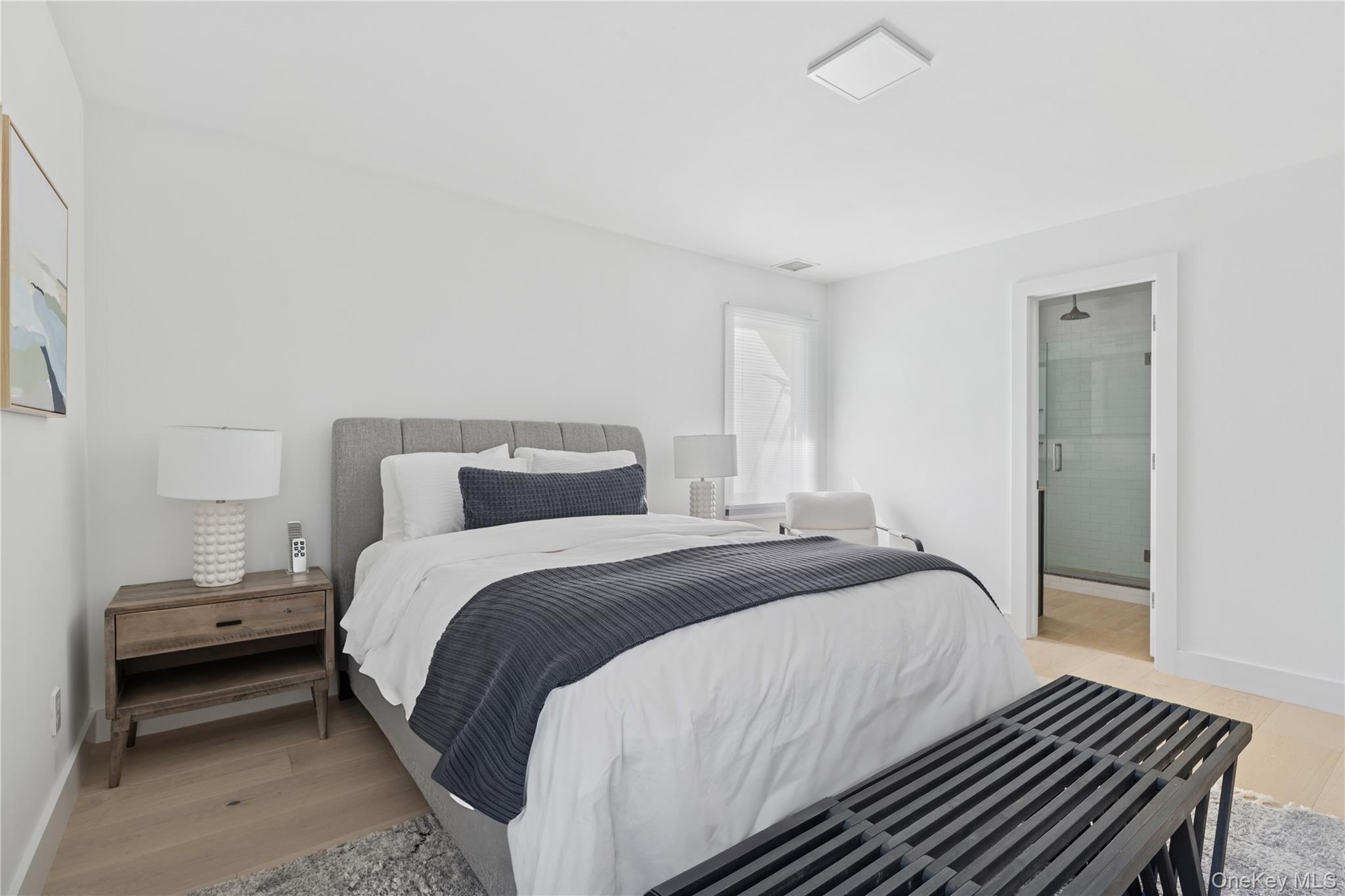 13 Sherwood Road Hampton Bays, NY 11946 - Photo 25 of 27 a bedroom with a bed and a night stand