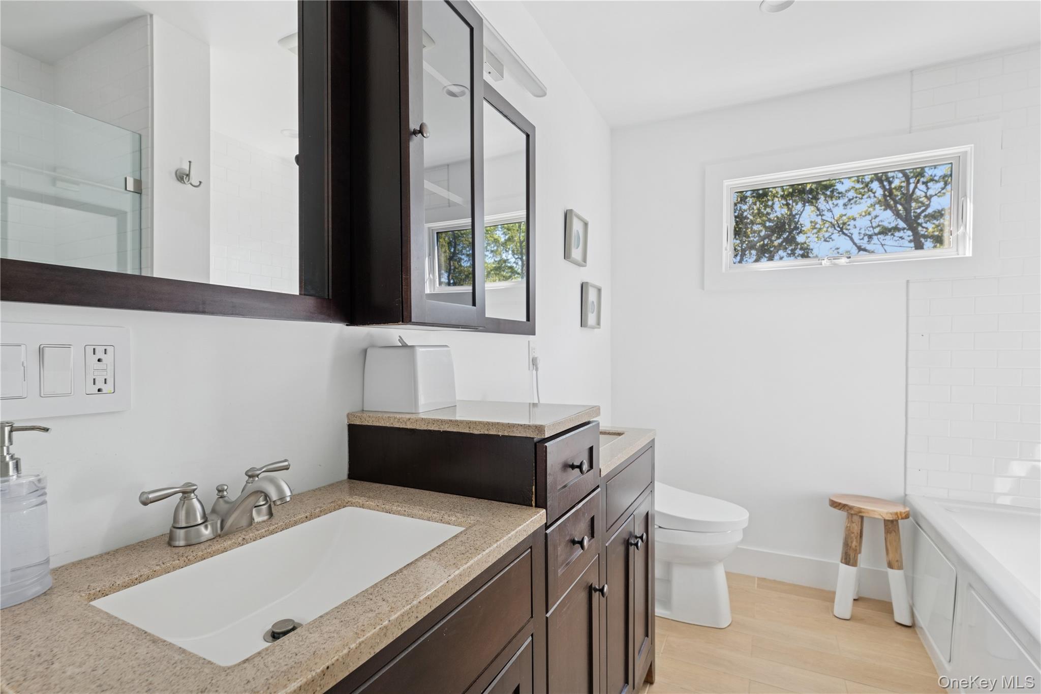 13 Sherwood Road Hampton Bays, NY 11946 - Photo 26 of 27 a bathroom with a sink vanity mirror and toilet
