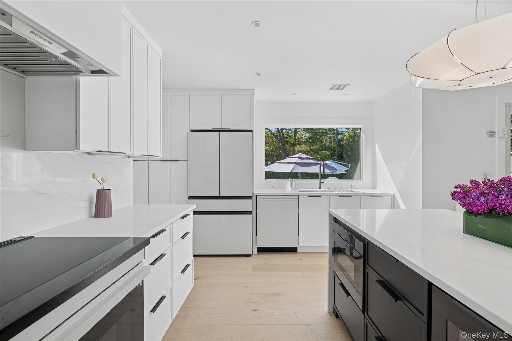 13 Sherwood Road Hampton Bays, NY 11946 - Photo 9 of 27 a kitchen with white cabinets and white appliances