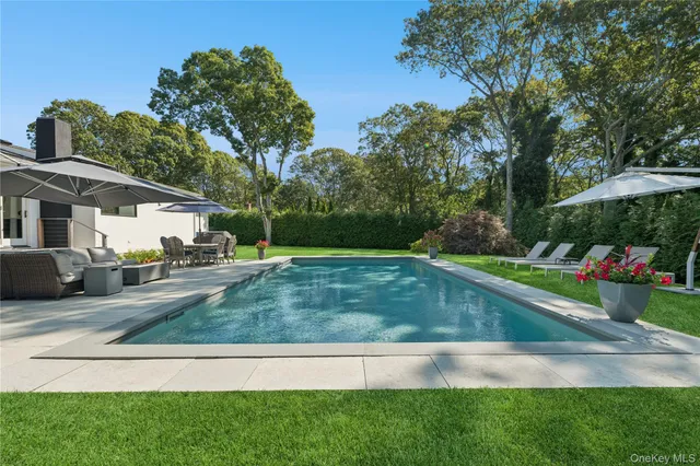 a view of yard with swimming pool and green space