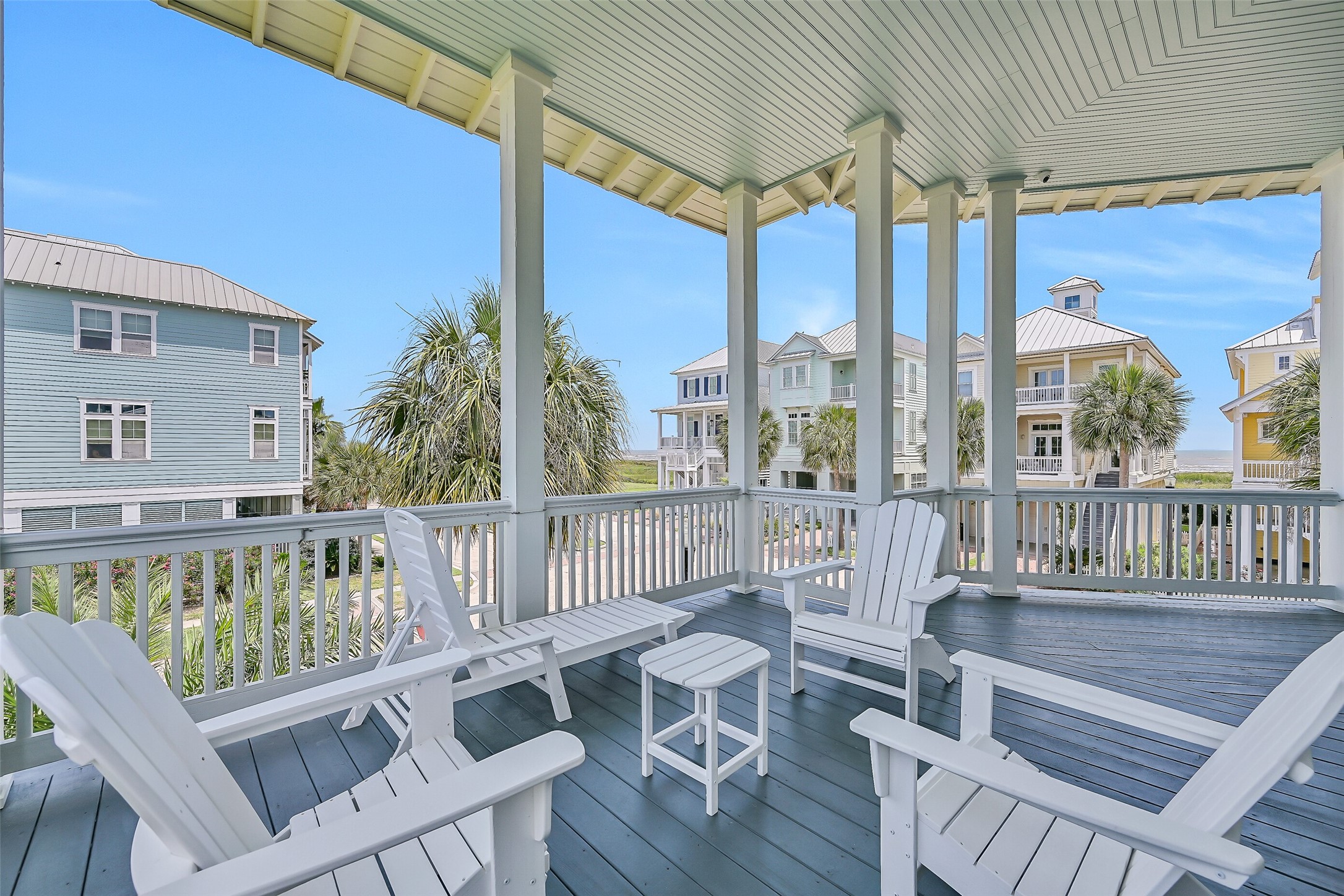 817 Positano Road Galveston, TX 77550 - Photo 45 of 50 From this inviting porch, enjoy views of the surrounding coastal community and beautifully maintained streetscapes. It's a peaceful place to relax while taking in the charm of Beachtown.