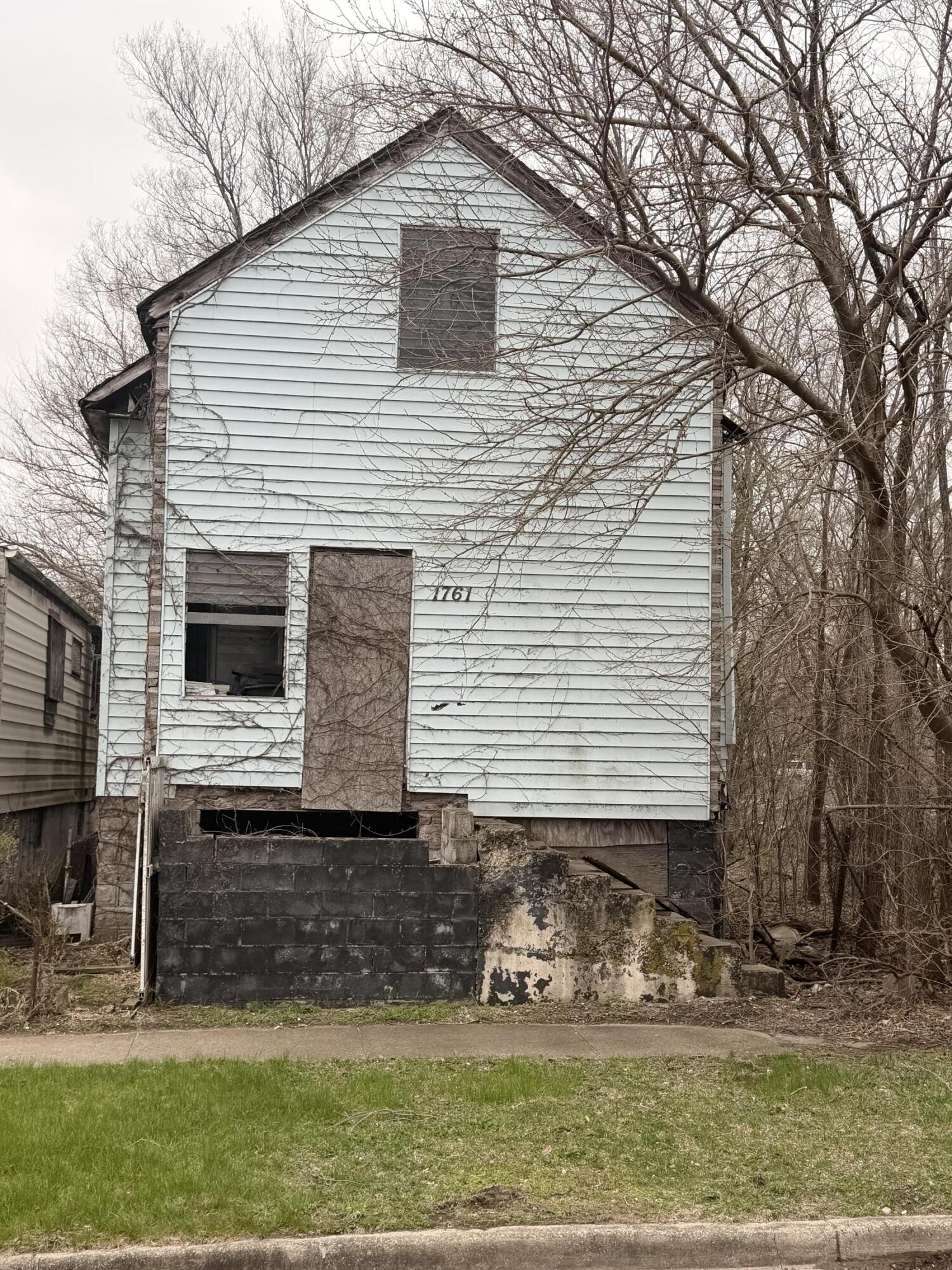 1761 Polk Street Gary, IN 46407 - Photo 1 of 2 a front view of a house with garden