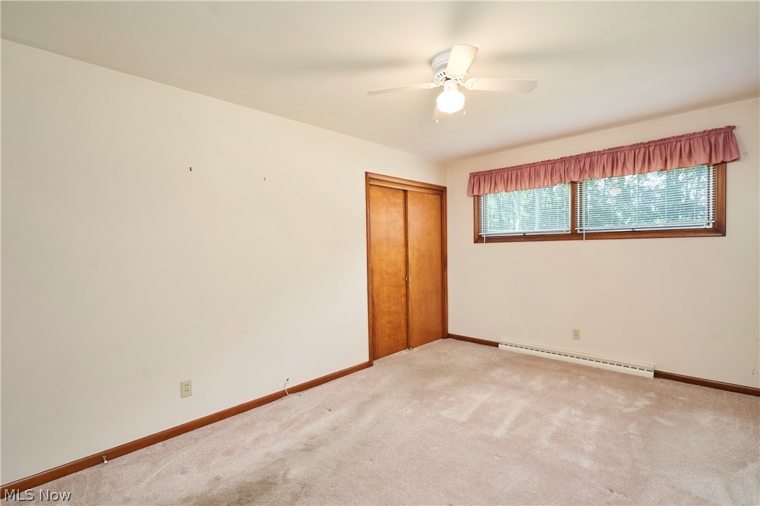 299 West Caston Road New Franklin, OH 44319 - Photo 13 of 23 Carpeted room with a ceiling fan with integrated lighting, wood-finish baseboards, and wood-finish sliding closet doors
