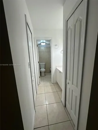 a bathroom with a granite countertop shower and a toilet