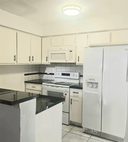 a kitchen with stainless steel appliances white cabinets and a sink