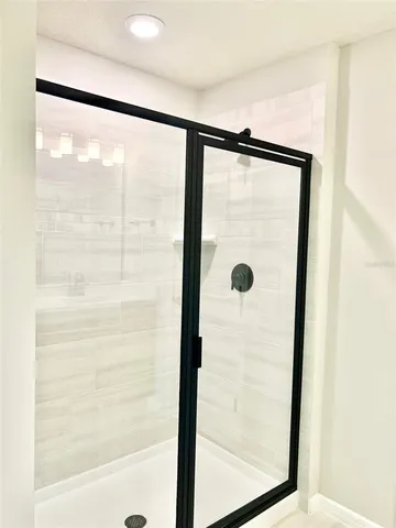 a bathroom with a glass shower door