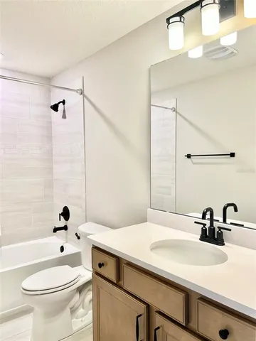a bathroom with a sink a toilet and a bathtub