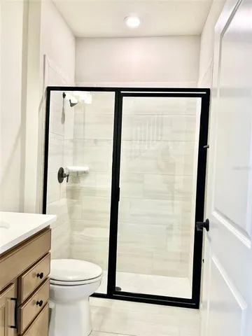 a bathroom with a shower toilet and sink