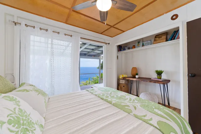 a bedroom with a bed and a desk